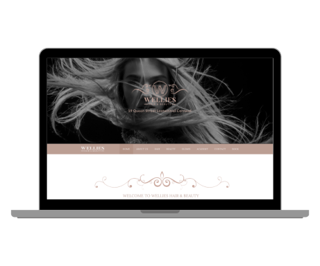 A stylish laptop displaying a black-and-white portrait with flowing hair.